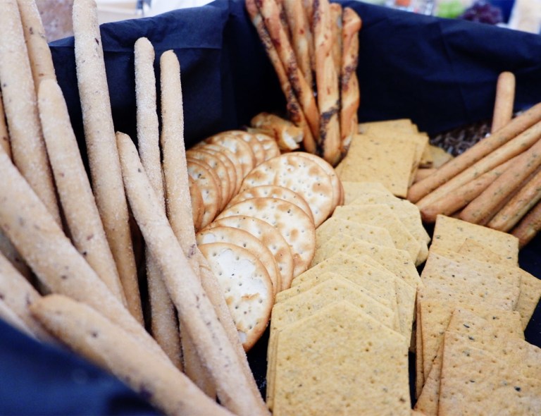 Different crackers including bread sticks in a box