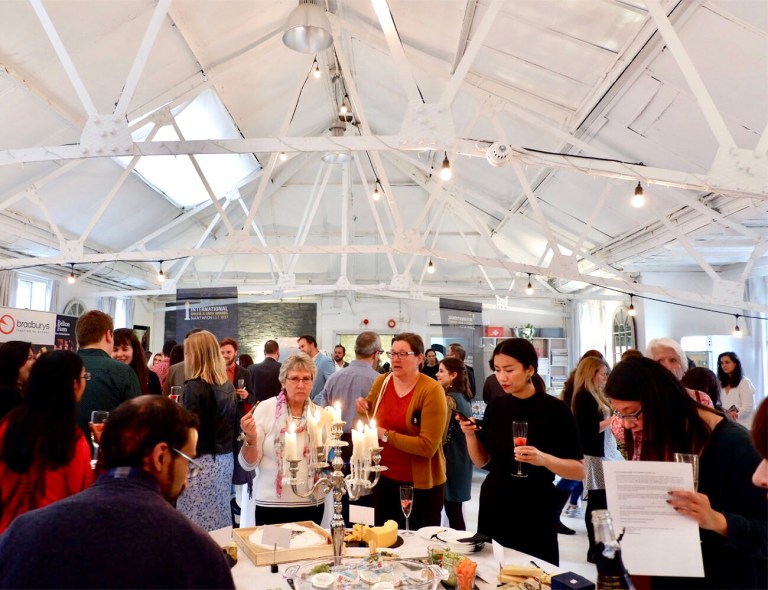Guests gathered around the cheese table