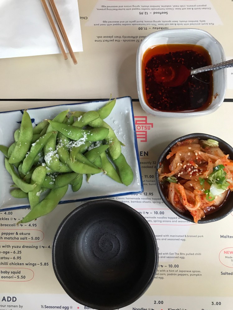 Flat lay of edamme beans and kimchi