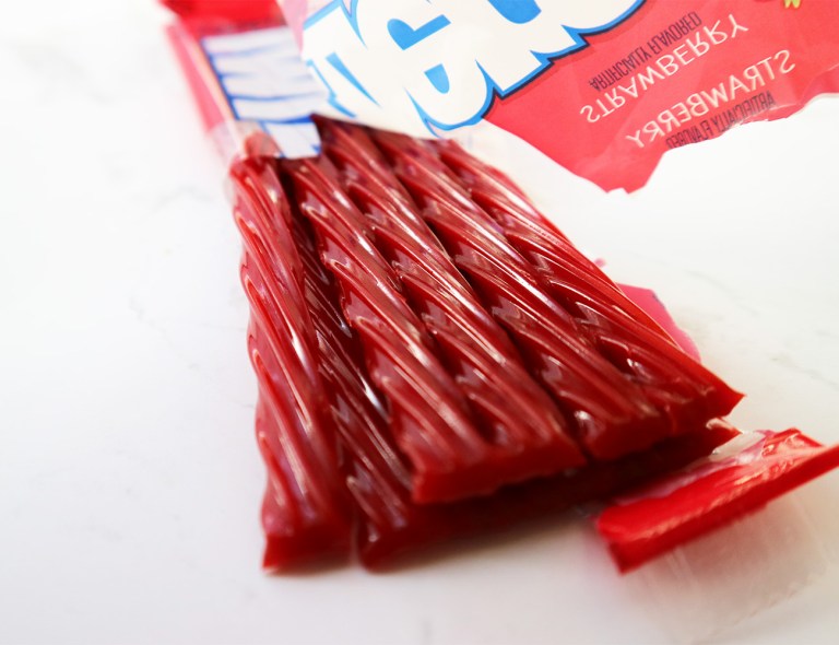 Twizzlers' packet is half off and the picture is show casing the beautiful sweets
