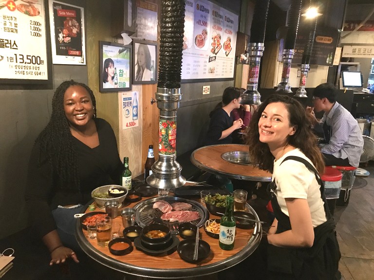 Rita sat opposite ends of Claire on the round BBQ table