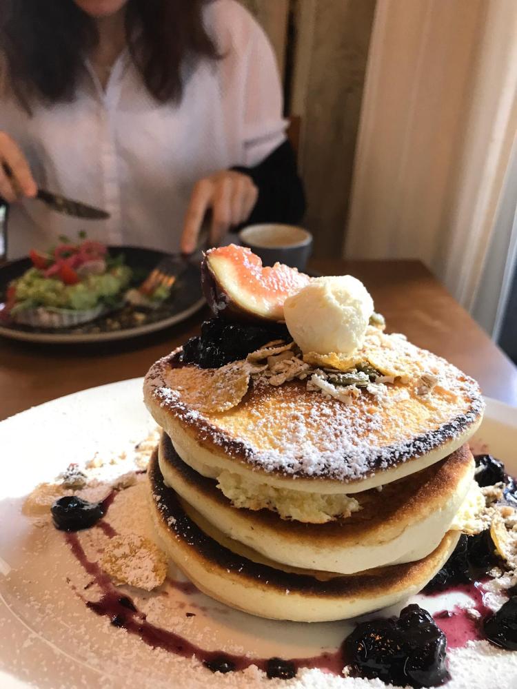 Wholemeal Pancakes stacked up with half a fig as decoration